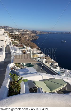 Imerovigli, Santorini, Greece - June 29, 2021: Whitewashed Houses With Terraces And Pools And A Beau