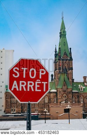 Arret Stop Sign Over Canadian Parliament Building In Ottava