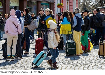 Uzhhorod, Ukraine - April 19, 2022: A Refugee Girl With A Suitcase Walks During A Peaceful March Of 