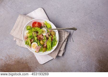 Healthy Tuna Salad With Fresh Lettuce, Cherry Tomatoes, Quail Egg And Olives In Bowl