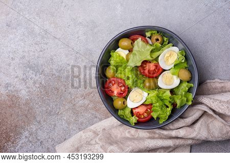 Healthy Salad With Fresh Lettuce, Cherry Tomatoes, Quail Egg And Olives