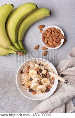 Healthy Breakfast With Oatmeal, Nuts, Banana And Chocolate Drops