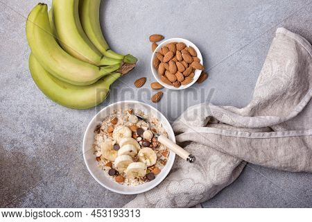 Healthy Breakfast With Oatmeal, Nuts, Banana And Chocolate Drops