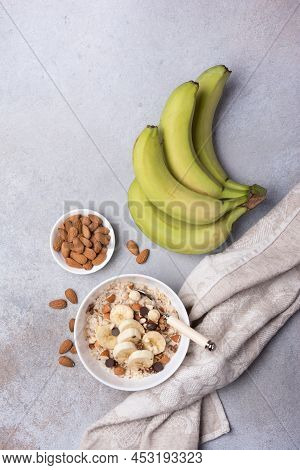 Healthy Breakfast With Oatmeal, Nuts, Banana And Chocolate Drops