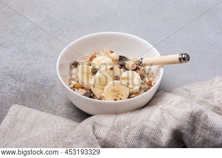 Healthy Breakfast With Oatmeal, Nuts, Banana And Chocolate Drops