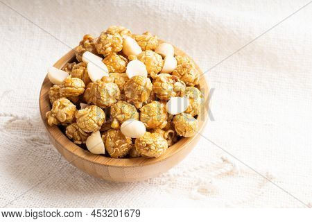 Caramel Popcorn With Macadamia Nut In Bamboo Wooden Bowl