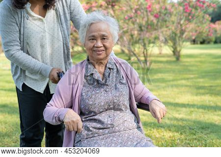 Caregiver Help And Care Asian Senior Or Elderly Old Lady Woman Patient Sitting And Happy On Wheelcha