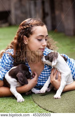 Beautiful Young Girl Having Fun With Her Small French Braque Puppies