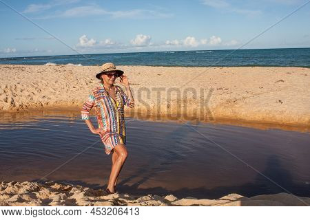 Woman Wearing Colorful Beachwear At The Beach Known As Pitinga, In Arraial D Ajuda, Bahia, Brazil