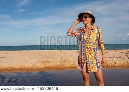 Woman Wearing Colorful Beachwear At The Beach Known As Pitinga, In Arraial D Ajuda, Bahia, Brazil