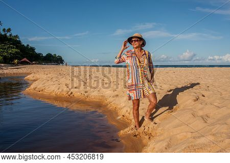 Woman Wearing Colorful Beachwear At The Beach Known As Pitinga, In Arraial D Ajuda, Bahia, Brazil