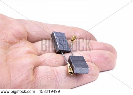 Carbon Brushes In Hand Isolated On A White Background. Brushes For Electric Motor.spare Parts For An