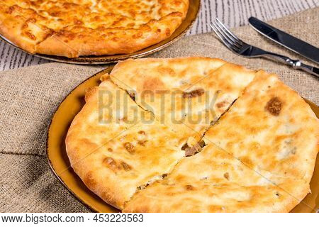 Kubdari With Meat On Old Wooden Table And Side Khachapuri, Georgian Cuisine