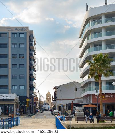 Larnaka, Cyprus - Feb 18, 2019: People Walking By Larnaca City Promenade. Hotel Buildins. Saint Laza