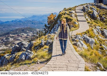 Woman Traveller In Mountain Landscape At National Park Lovcen, Montenegro. Travel To Montenegro Conc