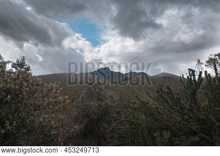 Landscape Of The Cotopaxi National Park With Green Trees And The Ruminahui Volcano Behind The Mounta