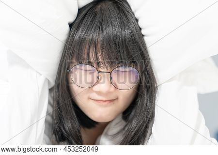 Glasses Woman Shy, Abash And Embarrass Under The White Pillow On Bed