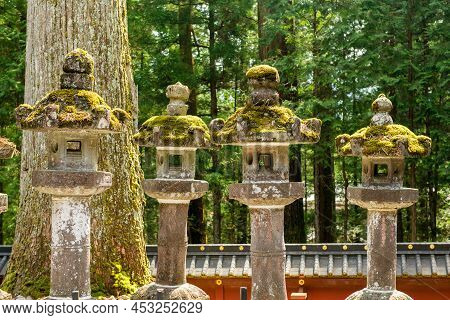 A Row Of Stone Lamps Covered On Green Moss At Nikkon Shrine
