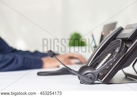 Call Center Staff Man Hand Point To Press The Button Number On The Phone Office Desk , Communication