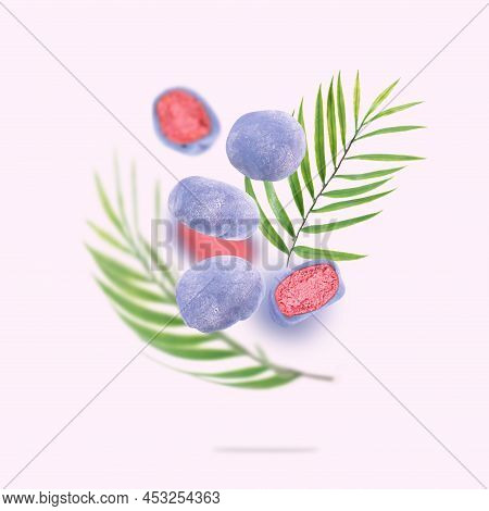 Japanese Rice Cakes Float In The Air. A Conceptual Composition Of Flying Mochi And Green Palm Leaves