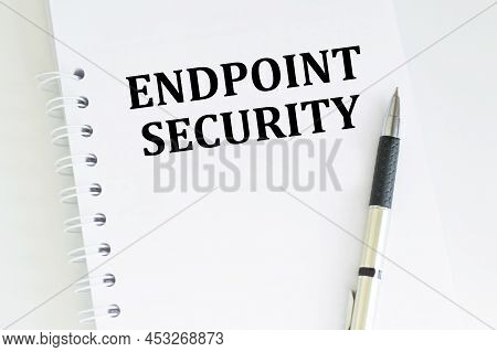 Text Endpoint Security On Notepad On An Isolated Table Next To A Pen