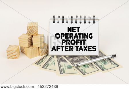 Business Concept. On A White Surface, Cubes, Dollars, A Pen And A Notepad With The Inscription - Net