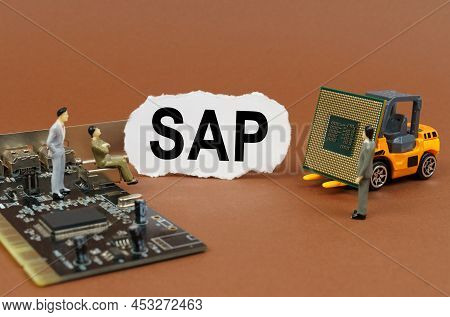 Technology And Business Concept. On A Brown Surface, A Loader With A Processor, A Microcircuit, Figu