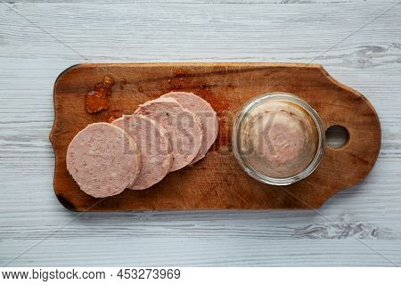 Homemade Jagdwurst On A Rustic Wooden Board On A White Wooden Background, Top View. Flat Lay, Overhe
