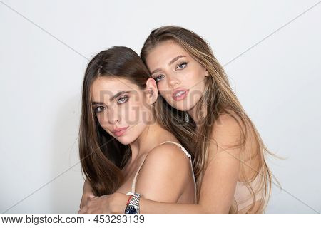 Close-up Of Couple Beautiful Girlfriends Models Hugging. Two Attractive Sexy Sensual Women Embrace, 