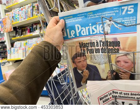 Paris, France - Apr 21, 2022: Pov Male Hand Buy Le Parisien Newspaper Press Headlines After Debate B