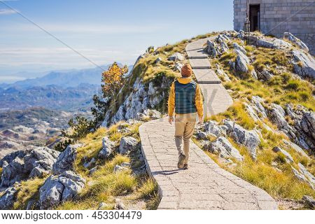 Man Traveller In Mountain Landscape At National Park Lovcen, Montenegro. Travel To Montenegro Concep
