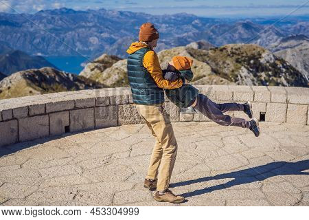 Dad And Son Travellers In Mountain Landscape At National Park Lovcen, Montenegro. Travel To Monteneg