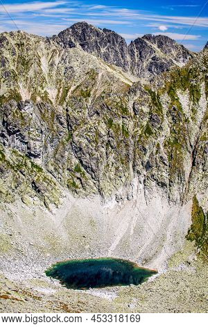 Small Lake And High Peaks In Mountains. Tarn Okruhle Pleso  In High Tatras Mountains, Slovakia