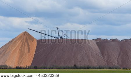 Giant Spreader Or Absetzer Machinery. A Large Dumper On A Landfill With Potash Ore. Extracting And M