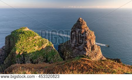 Cap Frehel Seascape From The Cliff With Boat Line And Rock. In Winter During The Sunrise