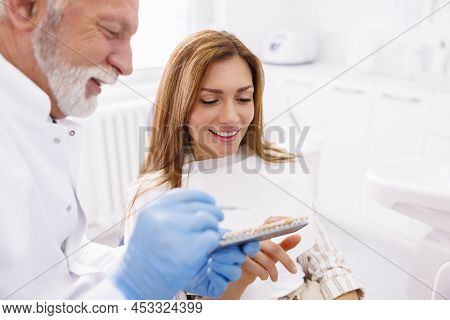 Dentist Showing To Patient Zirconium Dental Veneers Color Palette