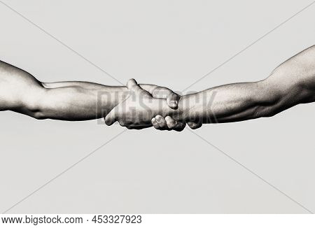 A Friendly Handshake. Two Hands, Shaking Hands. Two Hands, Helping Arm Of A Friend, Teamwork. Rescue