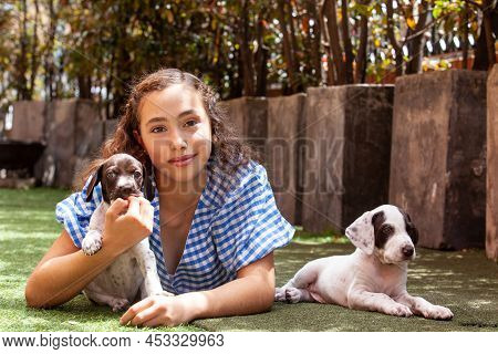 Beautiful Young Girl Having Fun With Her Small French Braque Puppies