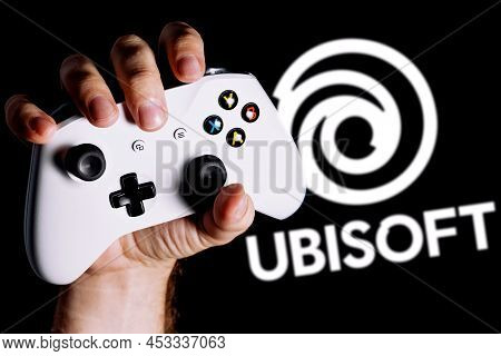Kazan, Russia - Apr 15, 2022: Ubisoft Is French Video Game Company. Gamepad Clutched In Hand On Blac