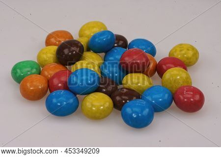 Closeup On A Colorful Pile Of Candy Coated Chocolate Mms Buttons On A White Background