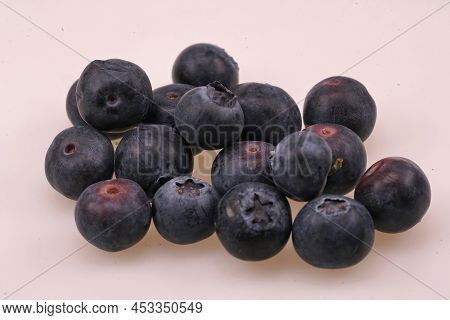 Closeup On A Small Pile Of Healthy European Blueberries, Vaccinium Myrtillus Against A White Backgro