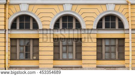 Three Windows In A Row On The Facade Of The Urban Historic Apartment Building Front View, Saint Pete