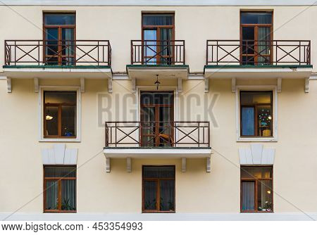 Several Balconies And Windows In A Row On The Facade Of The Modern Urban Apartment Building Front Vi