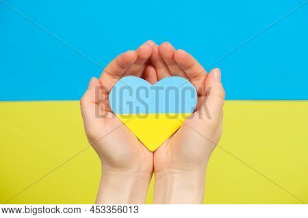 Yellow-blue Heart In The Color Of The Flag Of Ukraine In The Hands Of A Person, A Place For Text. Lo