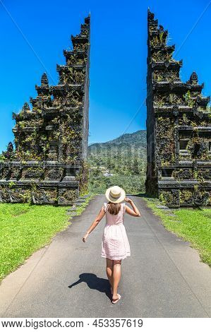 Woman Traveler At  Bali Handara Gate In Bali, Indonesia In A Sunny Day
