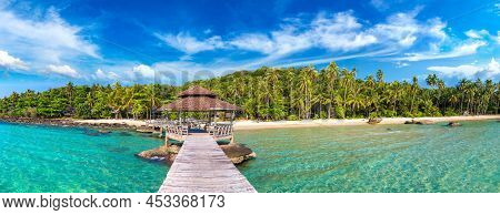 Panorama Of  Wooden Jetty (bridge) To Beautiful Tropical Beach