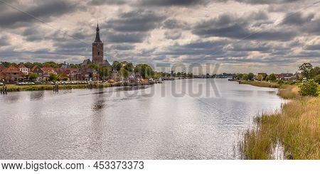 City Of Hasselt On The River Ijssel In Province Of Overijssel In The Netherlands. Under Clouded Summ