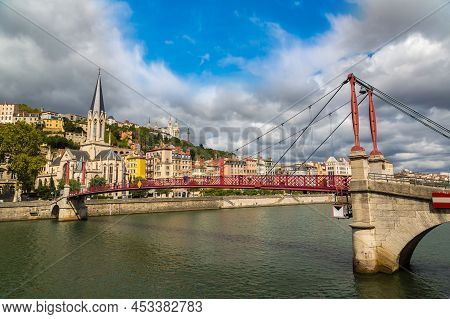 Pedestrian Saint Georges Footbridge And The Saint Georges Church In Lyon, France In A Beautiful Summ