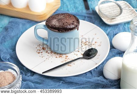 Mugcake Is Microwaved. Homemade Cupcake In A Mug Is On A Plate.
