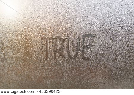 Foggy Glass On Window With Written Finger Word True
